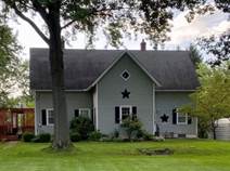 A house with a lawn and trees

Description automatically generated